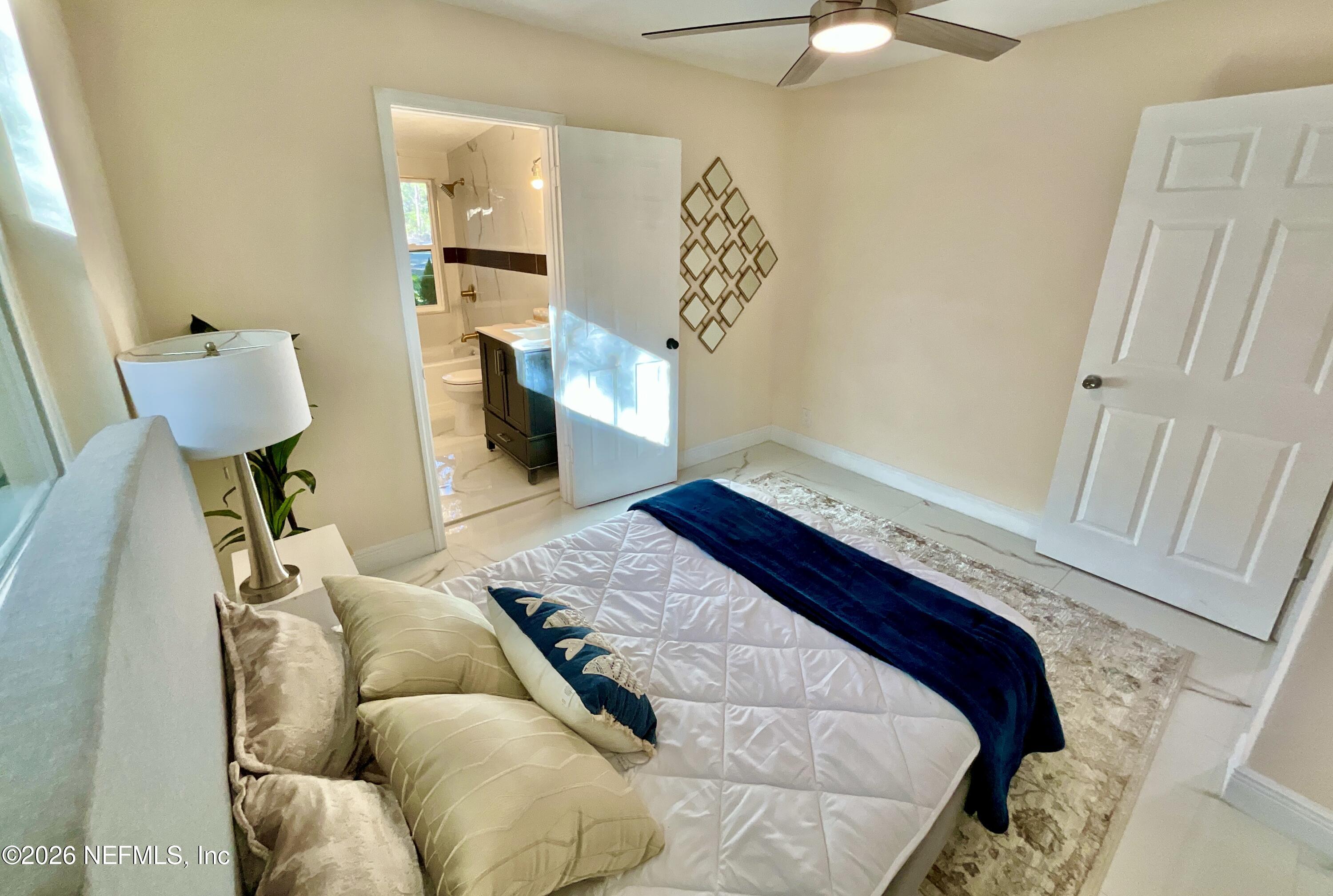 111 2nd Street Melrose, FL 32666 - Photo 19 of 36 a bedroom with a bed and a mirror