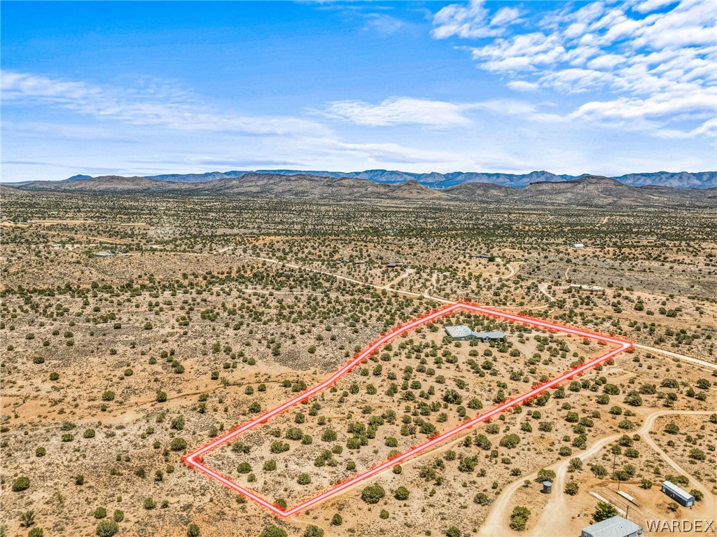 2401 North Stephan Road Kingman, AZ 86401 - Photo 89 of 92 Expansive desert parcel featuring a single-story residence with a light-colored roof, surrounded by native desert vegetation