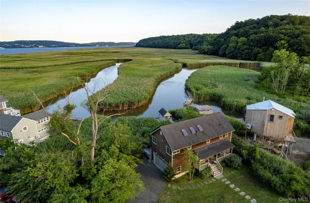 an aerial view of a house with garden space and lake view