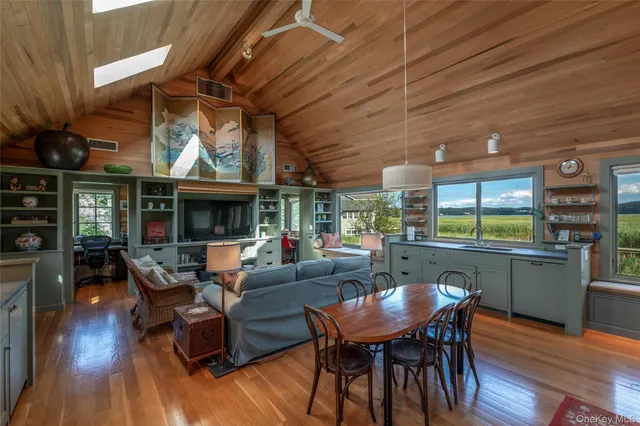 a view of a dining room with furniture window and wooden floor