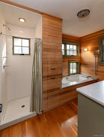 a view of a bathroom with a tub and shower