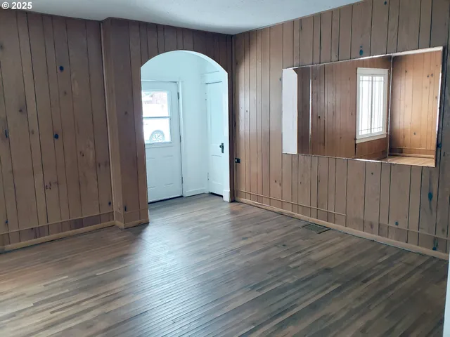 a room with wooden floors and window