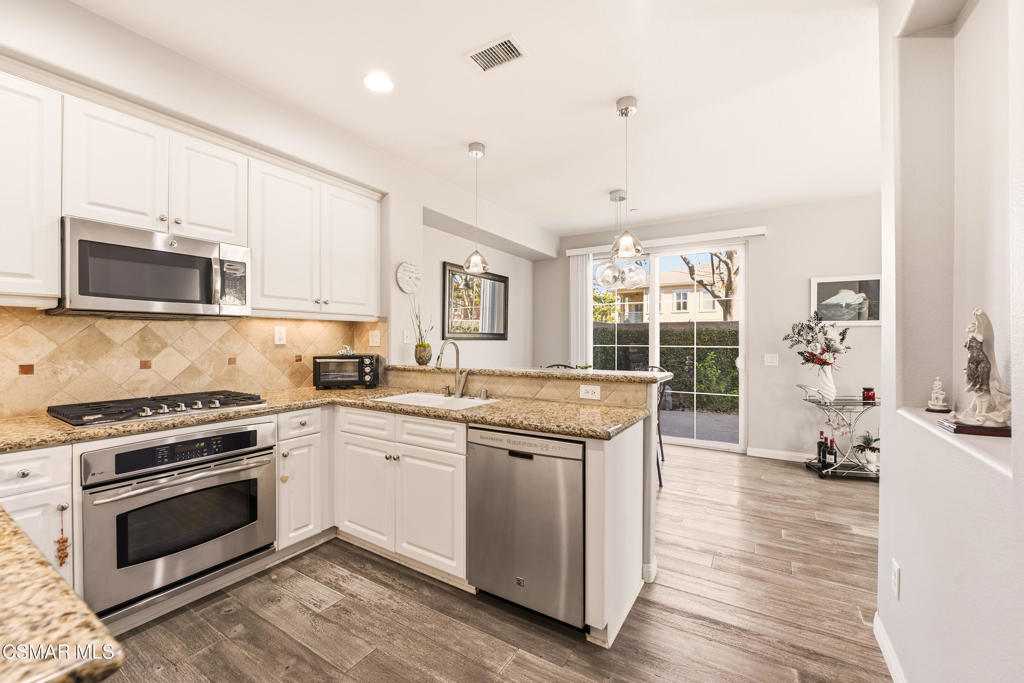 2964 Camelita Way, Unit C Simi Valley, CA 93063 - Photo 11 of 42 a kitchen with stainless steel appliances granite countertop a stove and a sink