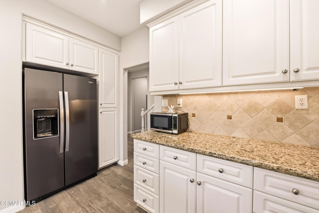 2964 Camelita Way, Unit C Simi Valley, CA 93063 - Photo 13 of 42 a kitchen with granite countertop white cabinets and stainless steel appliances
