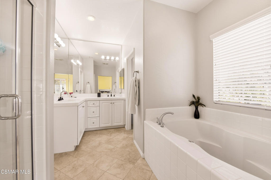 2964 Camelita Way, Unit C Simi Valley, CA 93063 - Photo 26 of 42 a bathroom with a bathtub a sink a window and a mirror