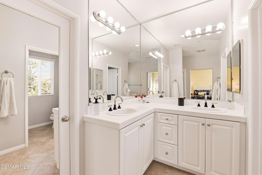 2964 Camelita Way, Unit C Simi Valley, CA 93063 - Photo 27 of 42 a bathroom with a sink a toilet a mirror and vanity