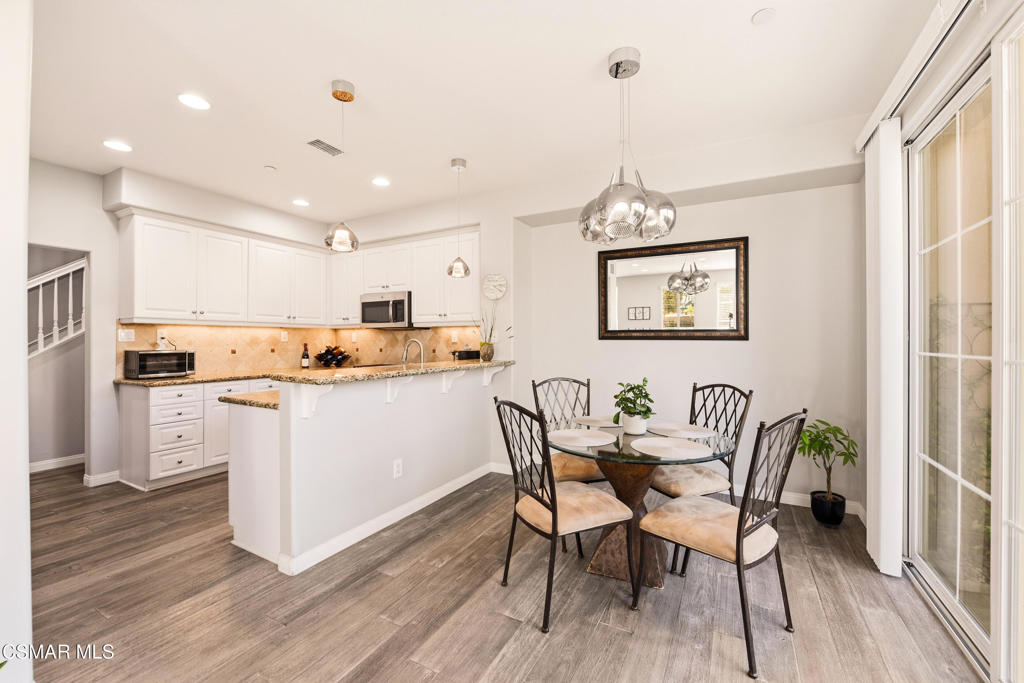 2964 Camelita Way, Unit C Simi Valley, CA 93063 - Photo 8 of 42 a dining room with stainless steel appliances kitchen island granite countertop a table chairs and a refrigerator
