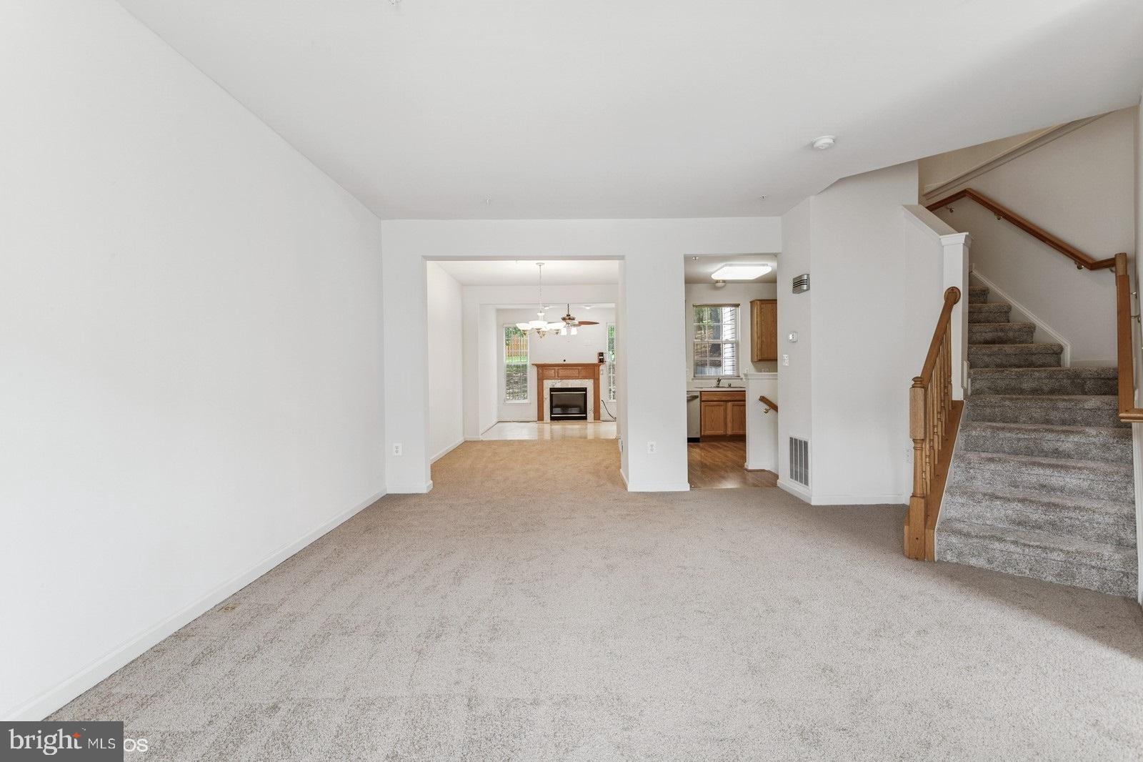 7315 Serenade Circle Clinton, MD 20735 - Photo 11 of 36 an empty room with an entryway and fireplace