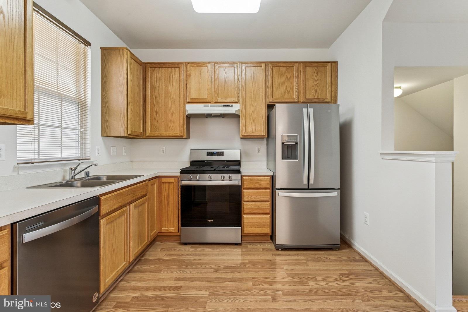 7315 Serenade Circle Clinton, MD 20735 - Photo 18 of 36 a kitchen with a refrigerator sink and cabinets