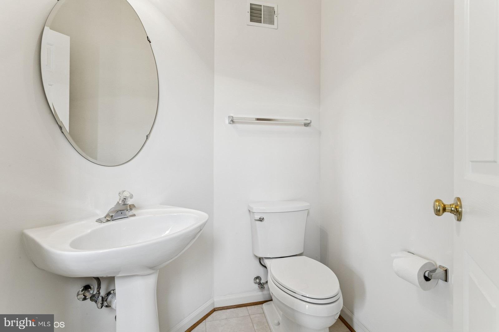 7315 Serenade Circle Clinton, MD 20735 - Photo 20 of 36 a bathroom with a toilet a sink and a mirror