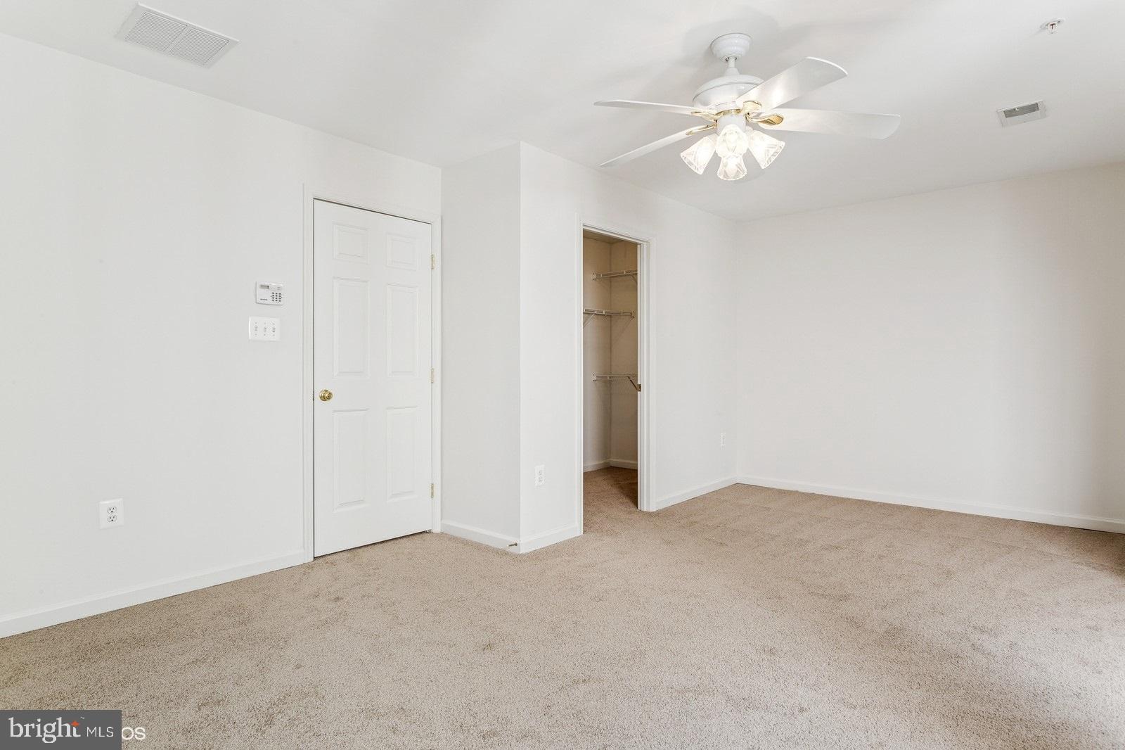 7315 Serenade Circle Clinton, MD 20735 - Photo 27 of 36 a view of an empty room with a chandelier fan