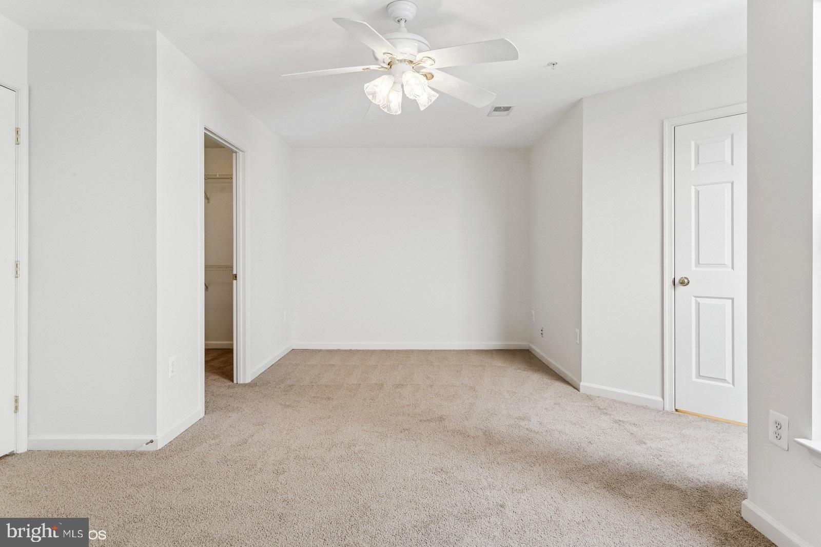 7315 Serenade Circle Clinton, MD 20735 - Photo 28 of 36 an empty room with a ceiling fan and a bathroom
