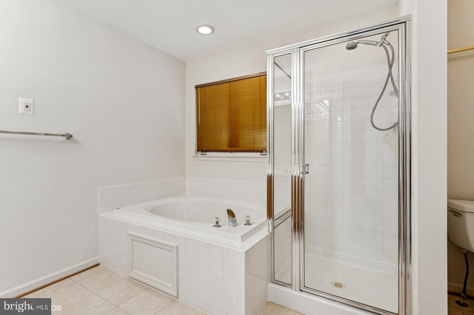 7315 Serenade Circle Clinton, MD 20735 - Photo 31 of 36 a bathroom with a bathtub and a shower