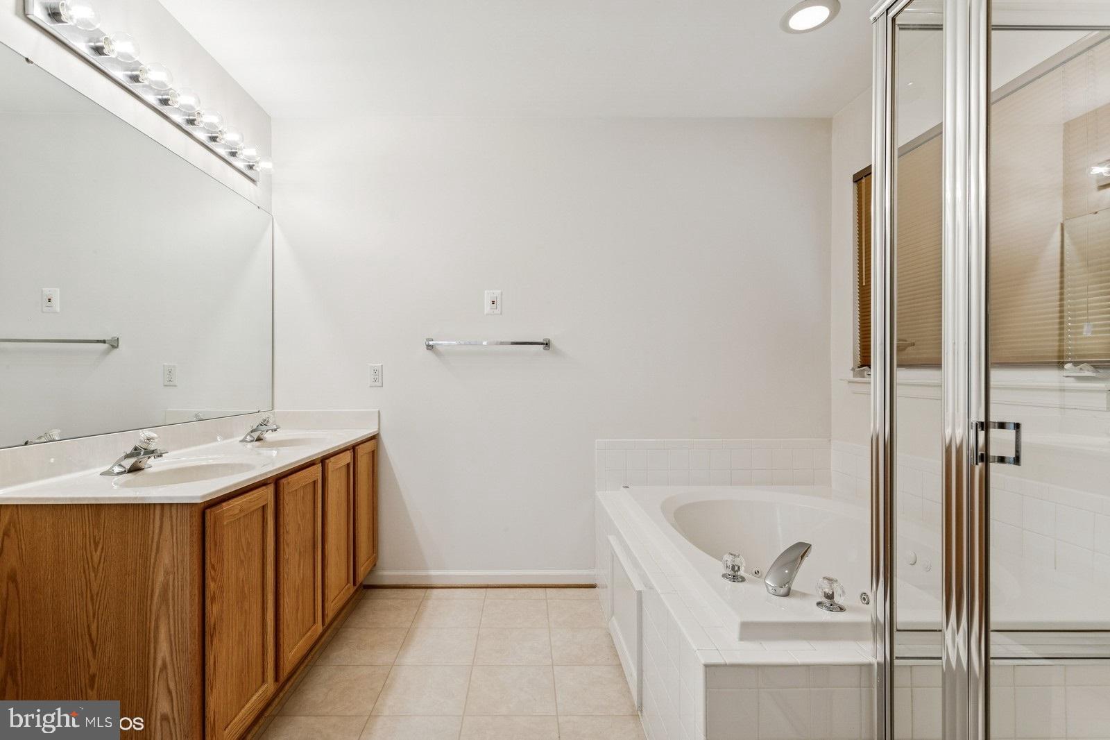 7315 Serenade Circle Clinton, MD 20735 - Photo 32 of 36 a bathroom with a tub sink and mirror