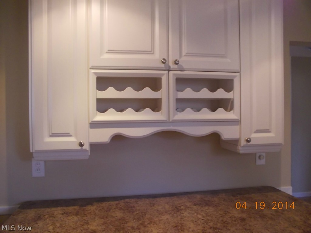 783 Edgewood Road Cleveland, OH 44143 - Photo 7 of 22 A close up of the wine rack and cabinetry complimented by gorgeous brand new counter tops!