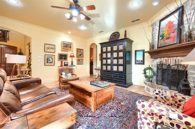 a living room with furniture a rug and a chandelier