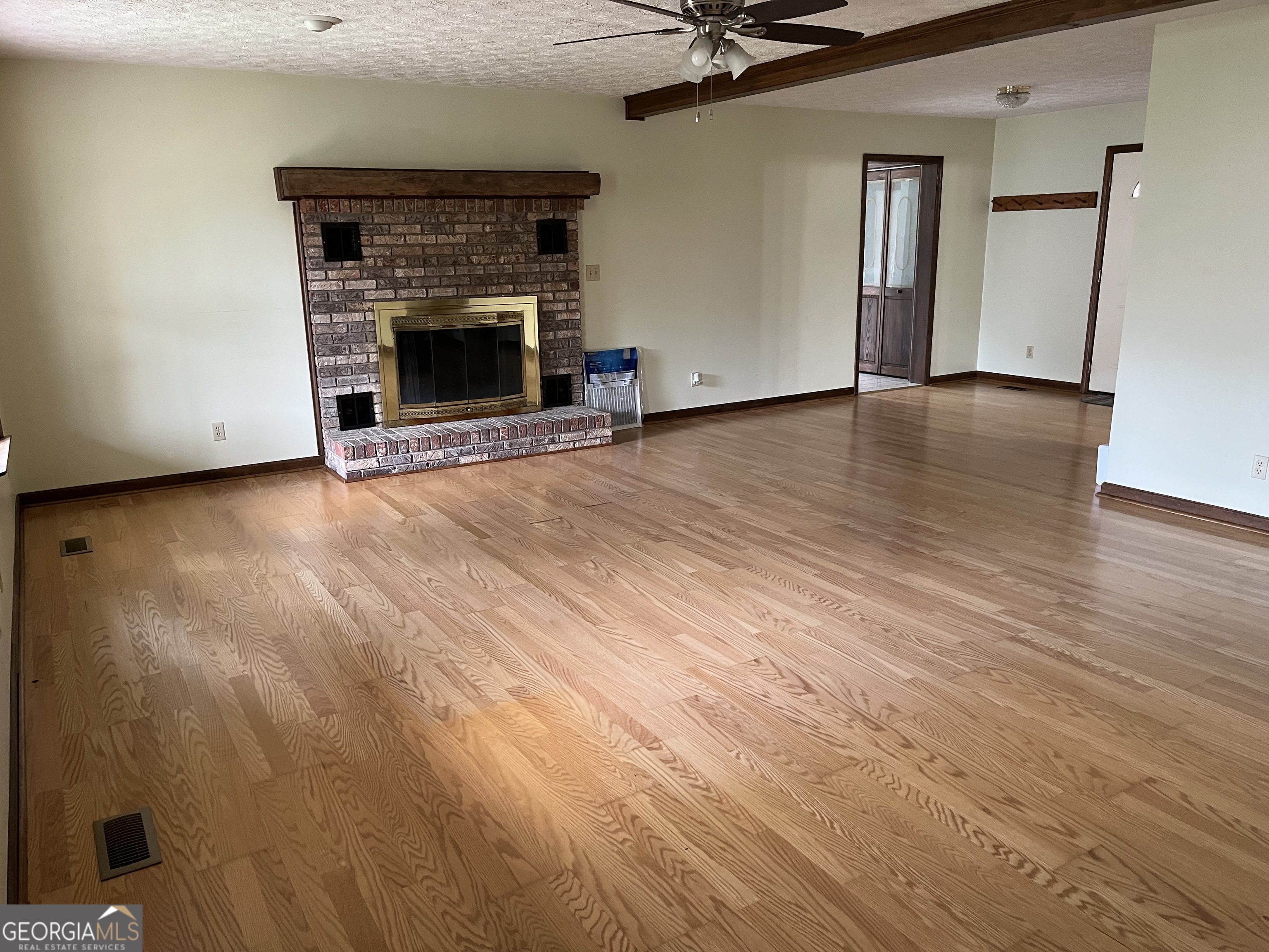 475 Davis Road Southwest Cave Spring, GA 30124 - Photo 19 of 27 an empty room with wooden floor fireplace and windows