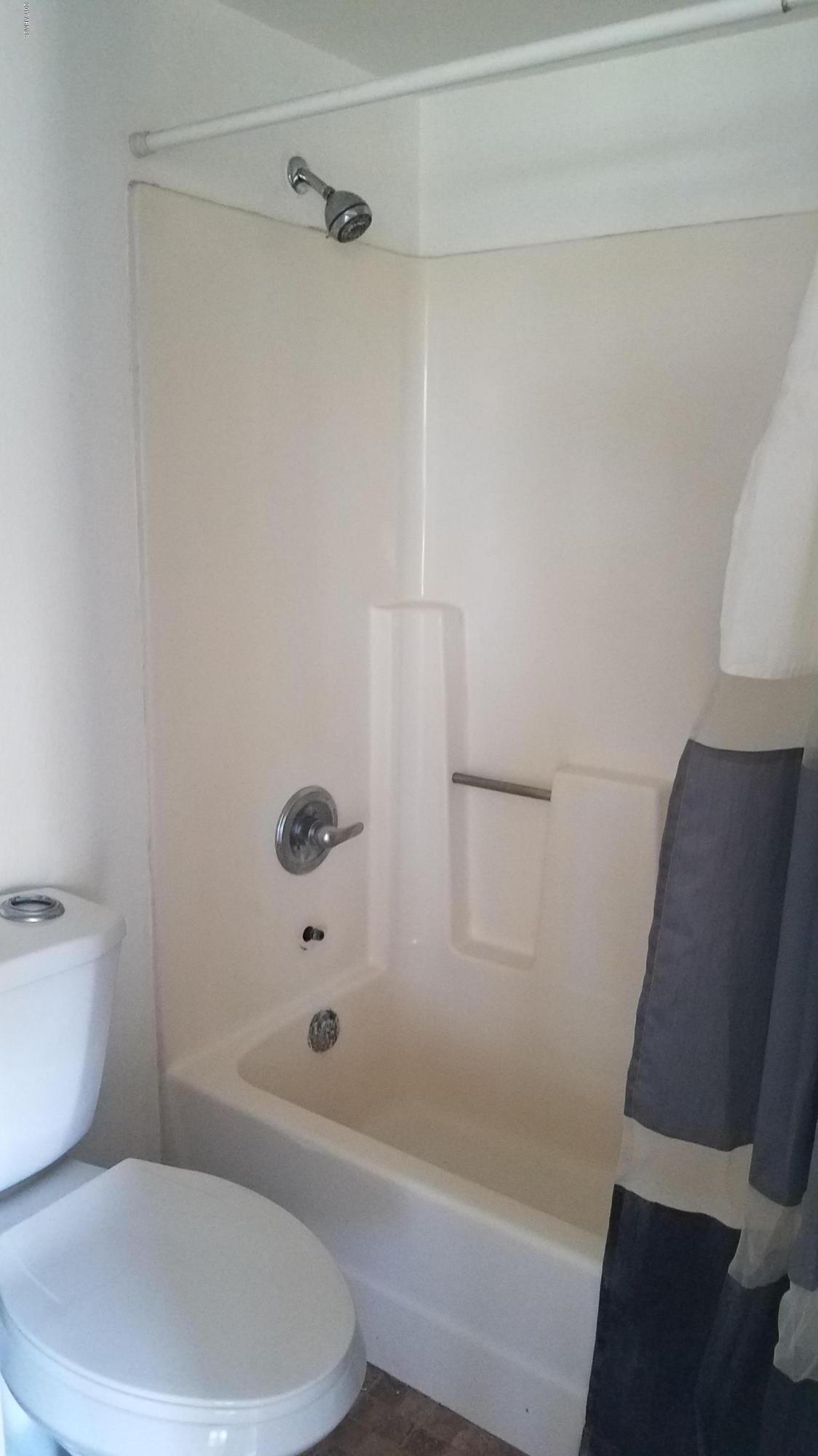 19601 North 7th Street, Unit 1049 Phoenix, AZ 85024 - Photo 19 of 26 a white toilet and tub sitting next to a bathroom sink