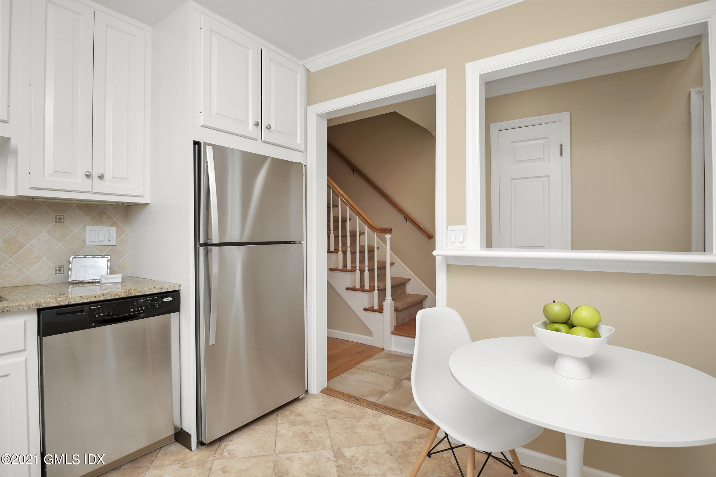 100 Strickland Road, Unit 1 Cos Cob, CT 06807 - Photo 8 of 29 a kitchen with stainless steel appliances a refrigerator and a table
