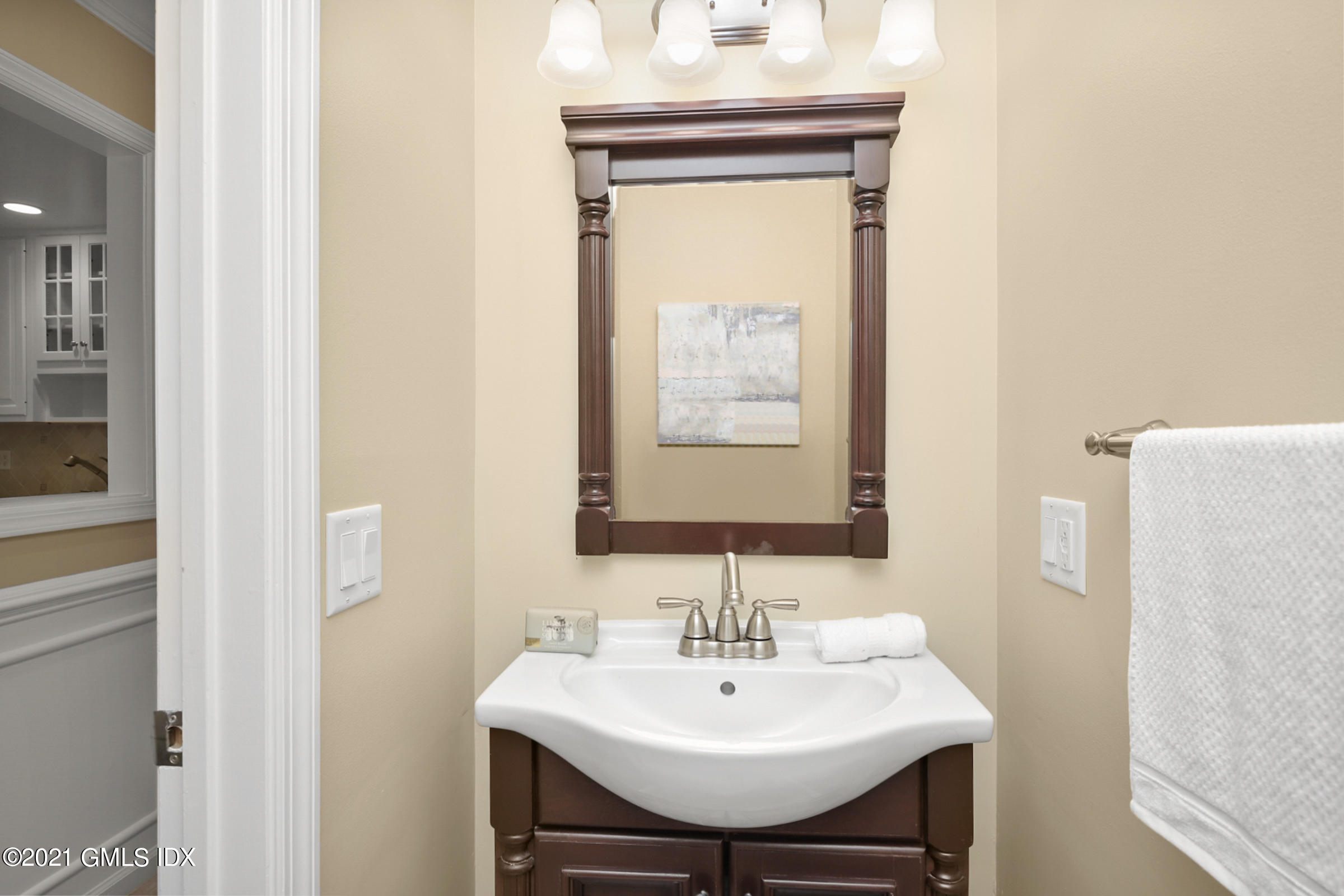 100 Strickland Road, Unit 1 Cos Cob, CT 06807 - Photo 9 of 29 a bathroom with a sink a mirror and a toilet