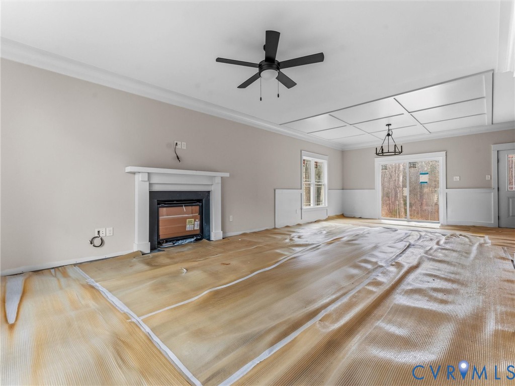 1545 Palmore Road Powhatan, VA 23139 - Photo 16 of 38 a view of a livingroom with a fireplace a ceiling fan and wooden floor