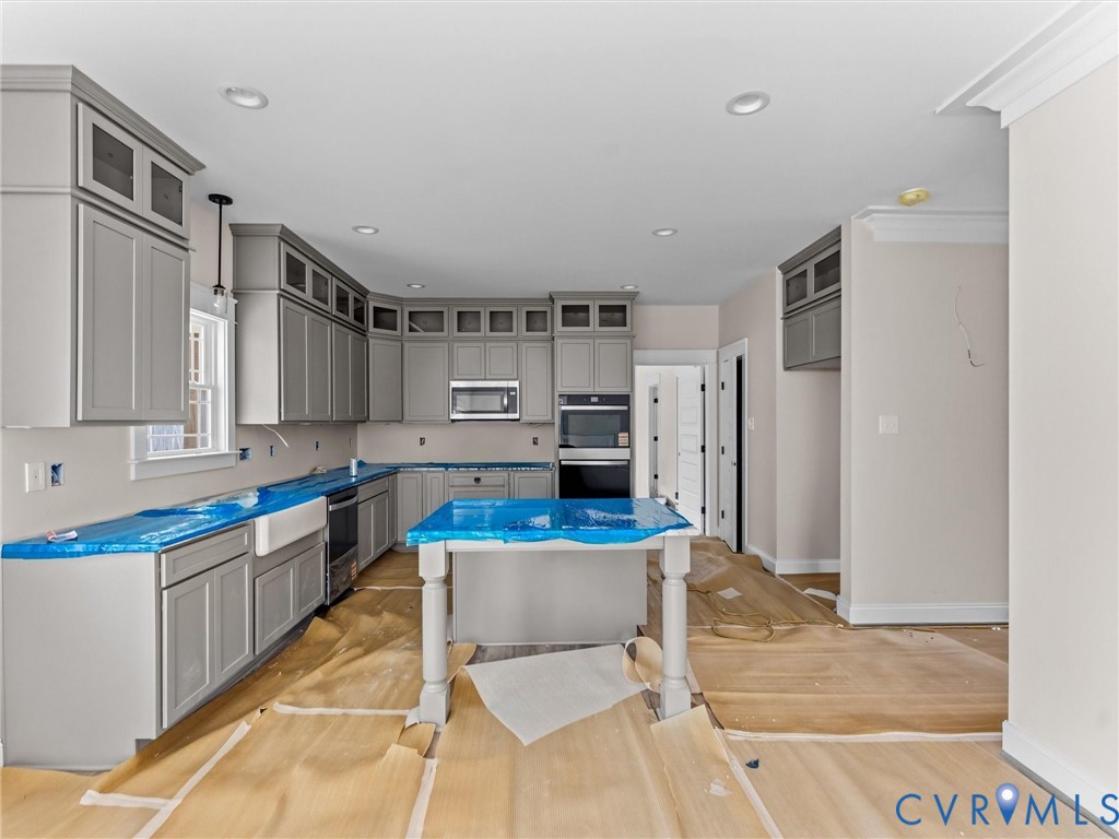 1545 Palmore Road Powhatan, VA 23139 - Photo 20 of 38 a kitchen with stainless steel appliances kitchen island granite countertop a refrigerator and a stove