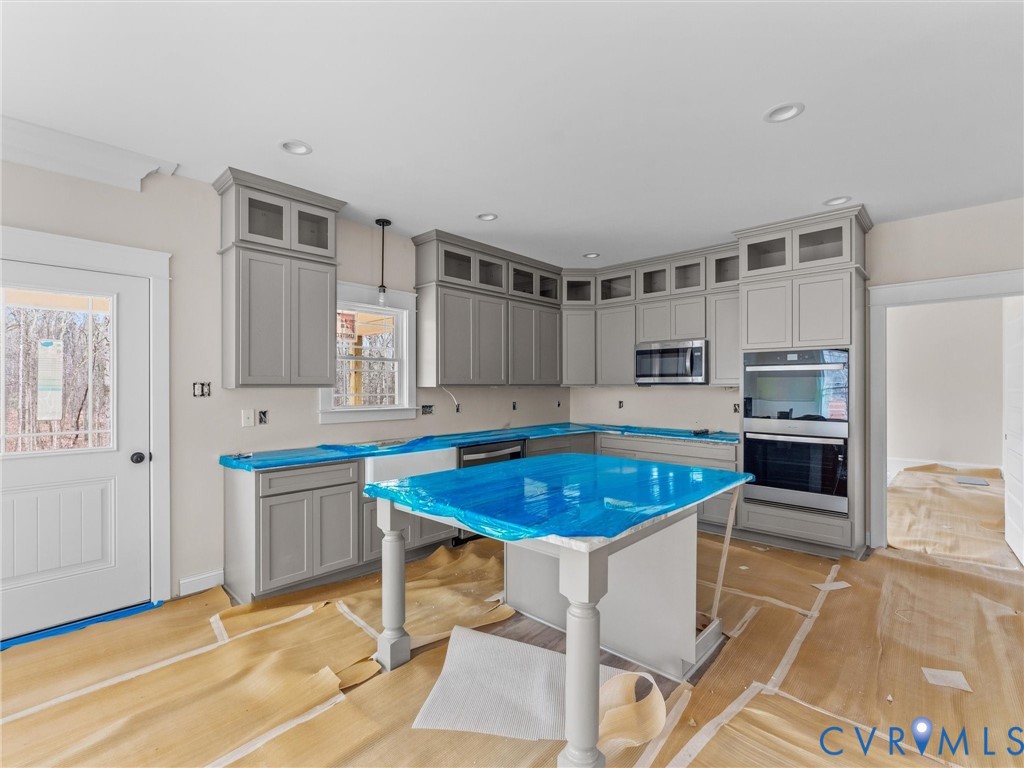 1545 Palmore Road Powhatan, VA 23139 - Photo 21 of 38 a kitchen with a table chairs sink and cabinets