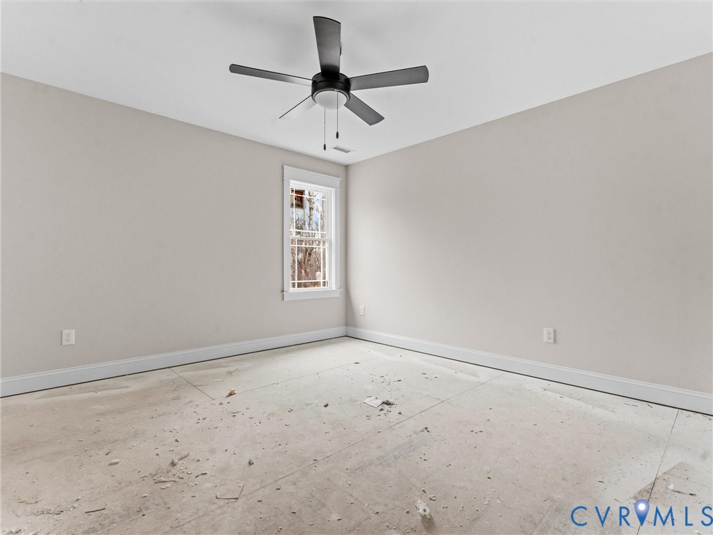 1545 Palmore Road Powhatan, VA 23139 - Photo 27 of 38 an empty room with a ceiling fan and window