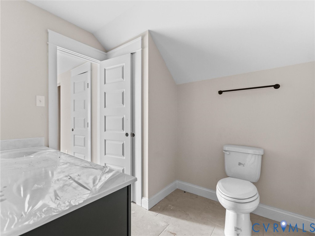 1545 Palmore Road Powhatan, VA 23139 - Photo 30 of 38 a bathroom with a granite countertop sink a toilet and a shower