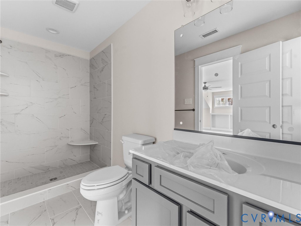 1545 Palmore Road Powhatan, VA 23139 - Photo 34 of 38 a bathroom with a sink a toilet and shower