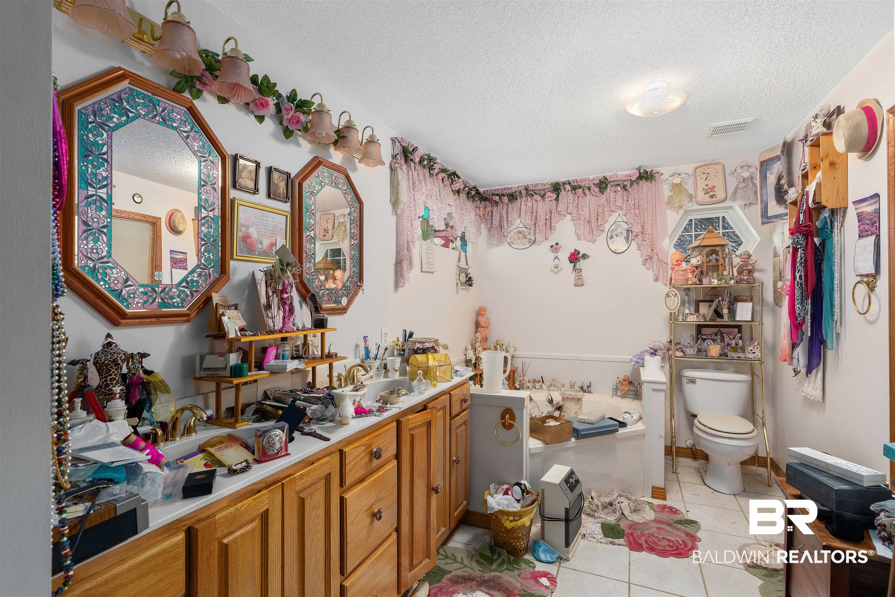 19413 Rada Road Silverhill, AL 36576 - Photo 20 of 37 Bathroom with vanity, tile patterned flooring, toilet, and a textured ceiling