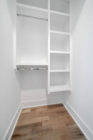 a view of a room with wooden floor