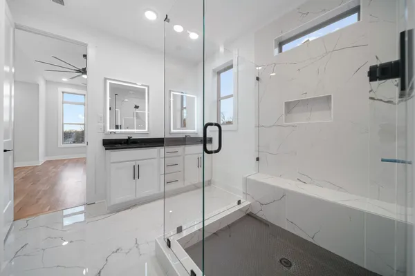 a bathroom with a tub sink shower and mirror