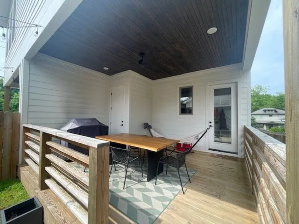 a view of a patio with a table and chairs