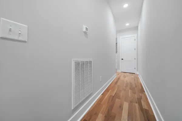 a view of a room with wooden floor and a balcony