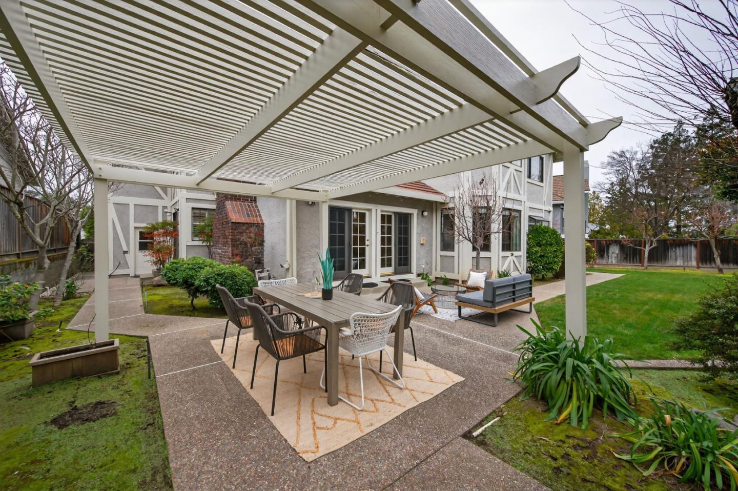1168 Spring Hill Way San Jose, CA 95120 - Photo 60 of 73 a view of a patio with table and chairs potted plants and a large tree