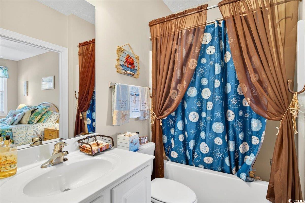 131 Waypoint Ridge Avenue, Unit 24 Little River, SC 29566 - Photo 13 of 39 Ensuite bathroom featuring shower / bathtub combination with curtain and vanity