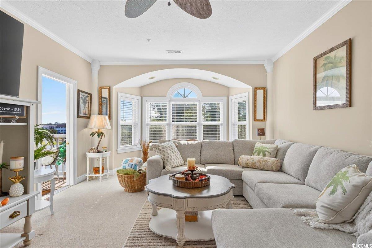 131 Waypoint Ridge Avenue, Unit 24 Little River, SC 29566 - Photo 23 of 39 Carpeted living area with ornamental molding, a ceiling fan, and a textured ceiling