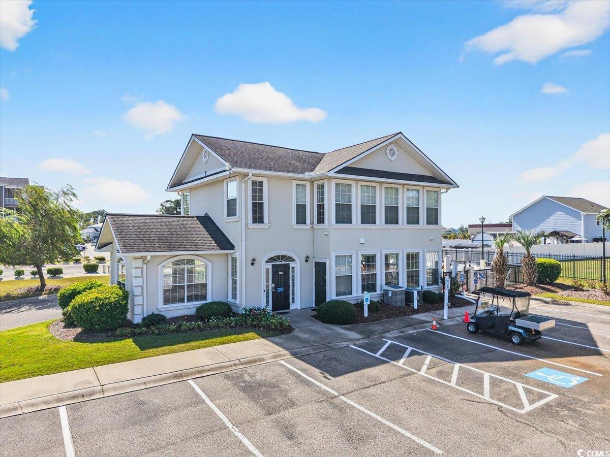 131 Waypoint Ridge Avenue, Unit 24 Little River, SC 29566 - Photo 37 of 39 View of front facade featuring uncovered parking, stucco siding, and roof with shingles