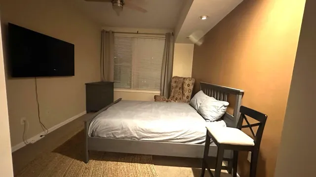a bedroom with a bed and a flat screen tv