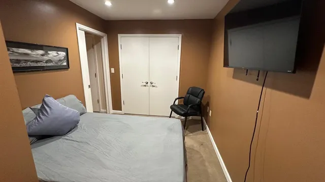 a bedroom with a bed and a walk in closet