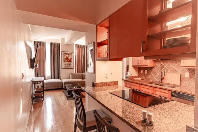 a kitchen with granite countertop a sink and a stove top oven