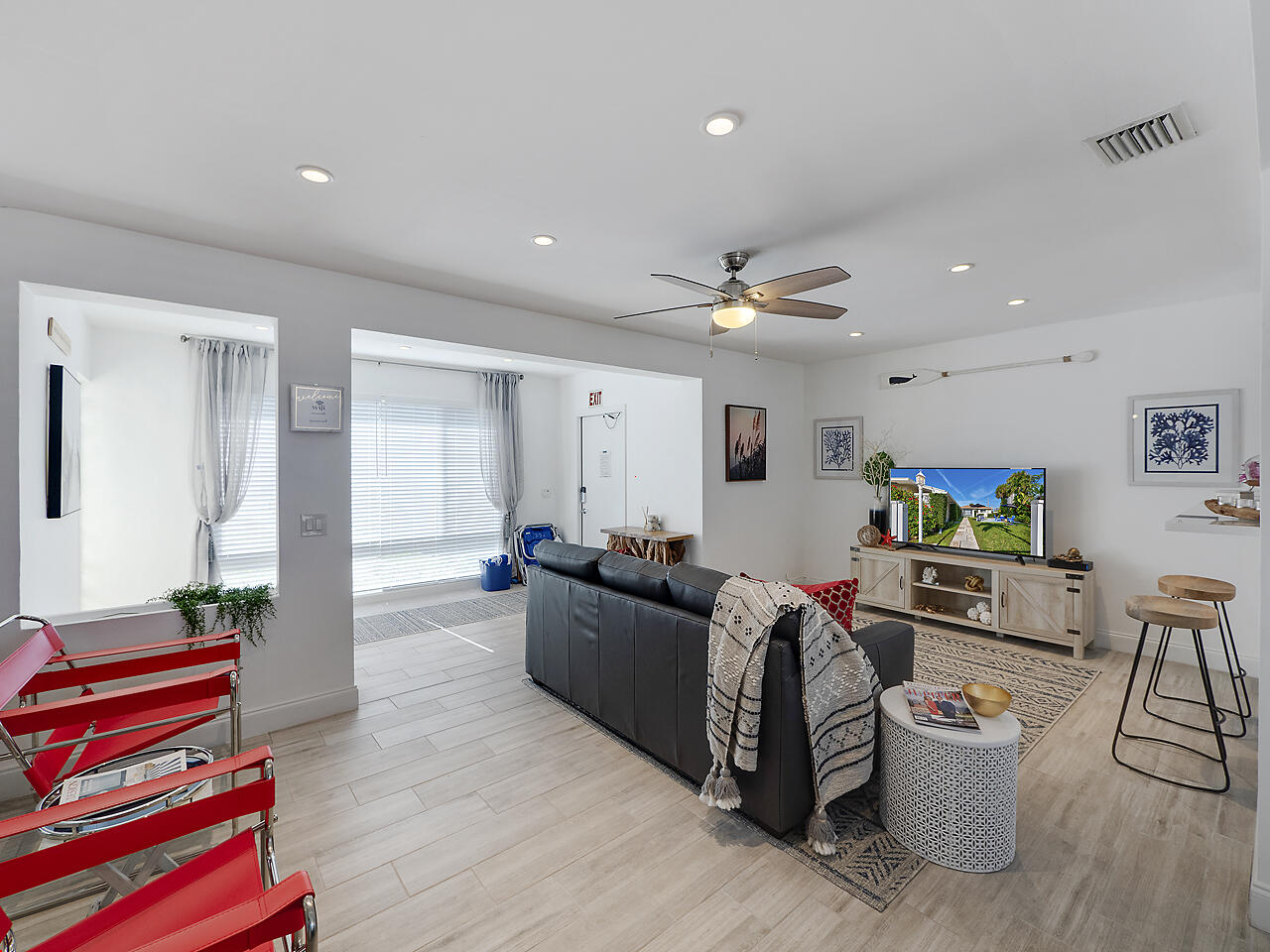 1236 Beach Road, Unit 3 Singer Island, FL 33404 - Photo 16 of 25 a living room with furniture and a flat screen tv