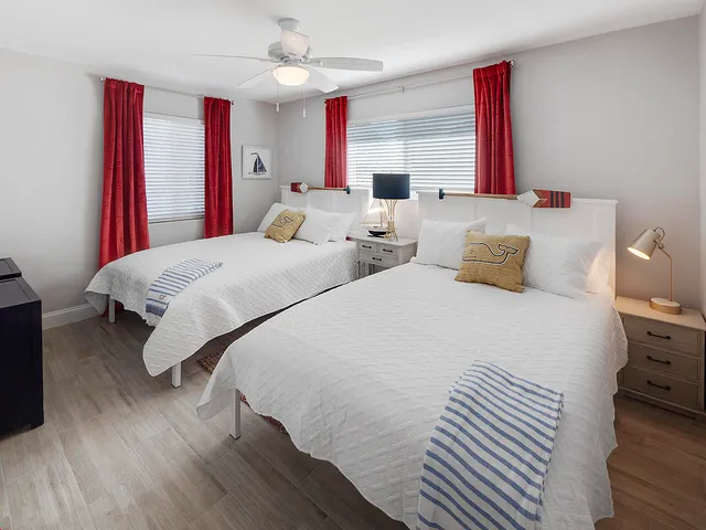 a bedroom with two beds and a chandelier