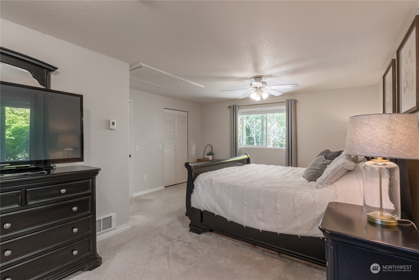 16520 4th Drive Southeast Bothell, WA 98012 - Photo 13 of 32 a bedroom with a bed and a flat screen tv