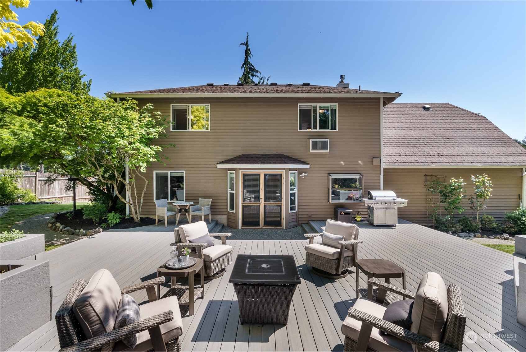 16520 4th Drive Southeast Bothell, WA 98012 - Photo 20 of 32 a view of a patio with table and chairs with a barbeque grill and a small yard