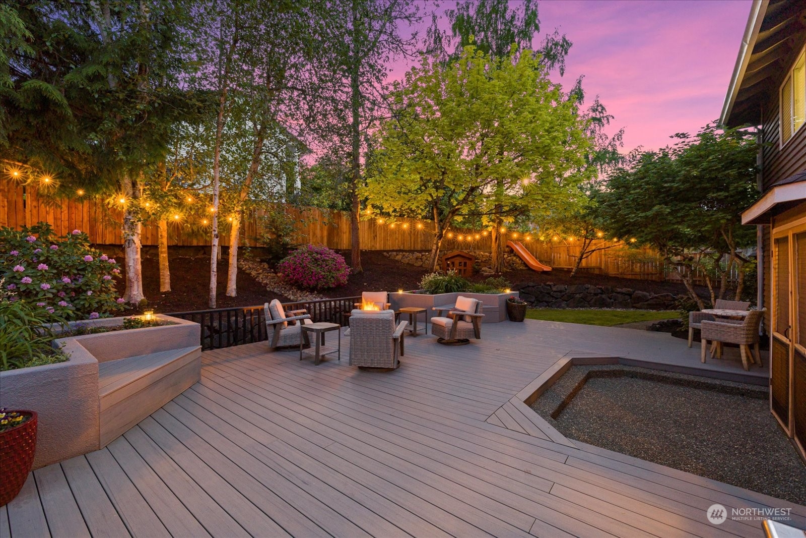 16520 4th Drive Southeast Bothell, WA 98012 - Photo 27 of 32 a view of a patio with couches and table and chairs with wooden floor and fence