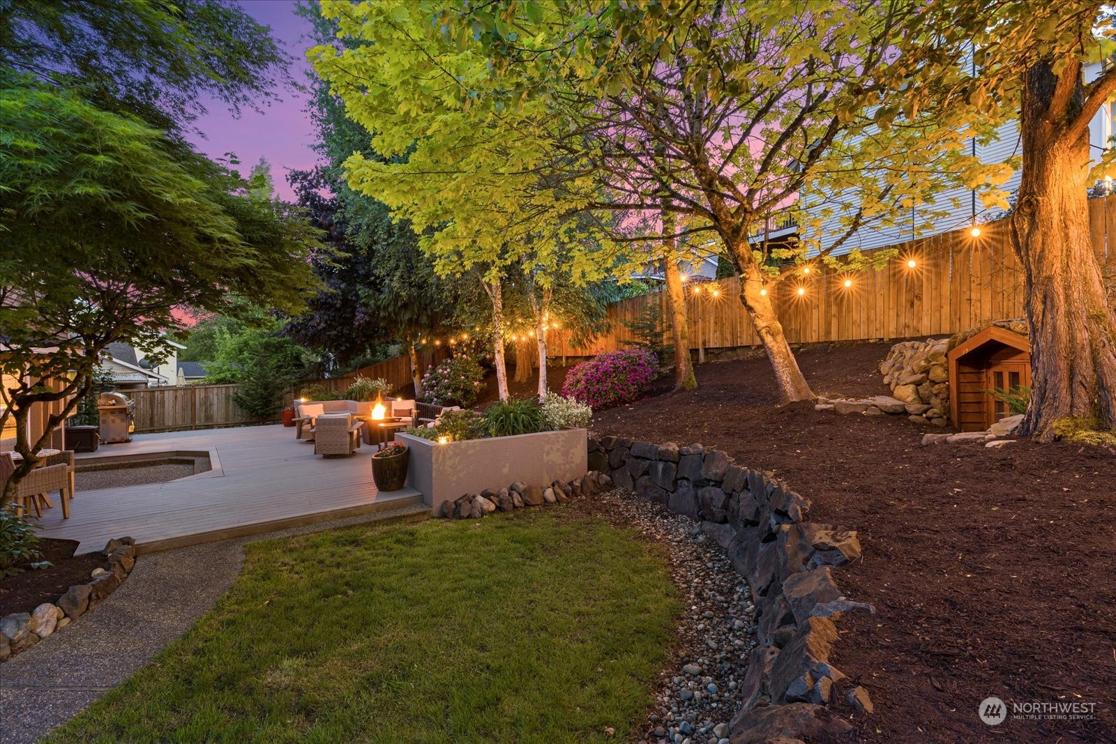 16520 4th Drive Southeast Bothell, WA 98012 - Photo 30 of 32 a view of a backyard with table and chairs potted plants and large trees