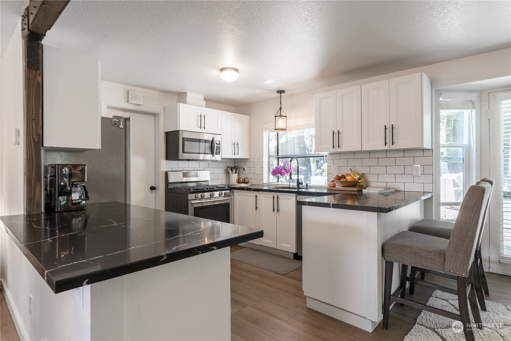 16520 4th Drive Southeast Bothell, WA 98012 - Photo 5 of 32 a kitchen with granite countertop stainless steel appliances a sink a counter top space cabinets and appliances