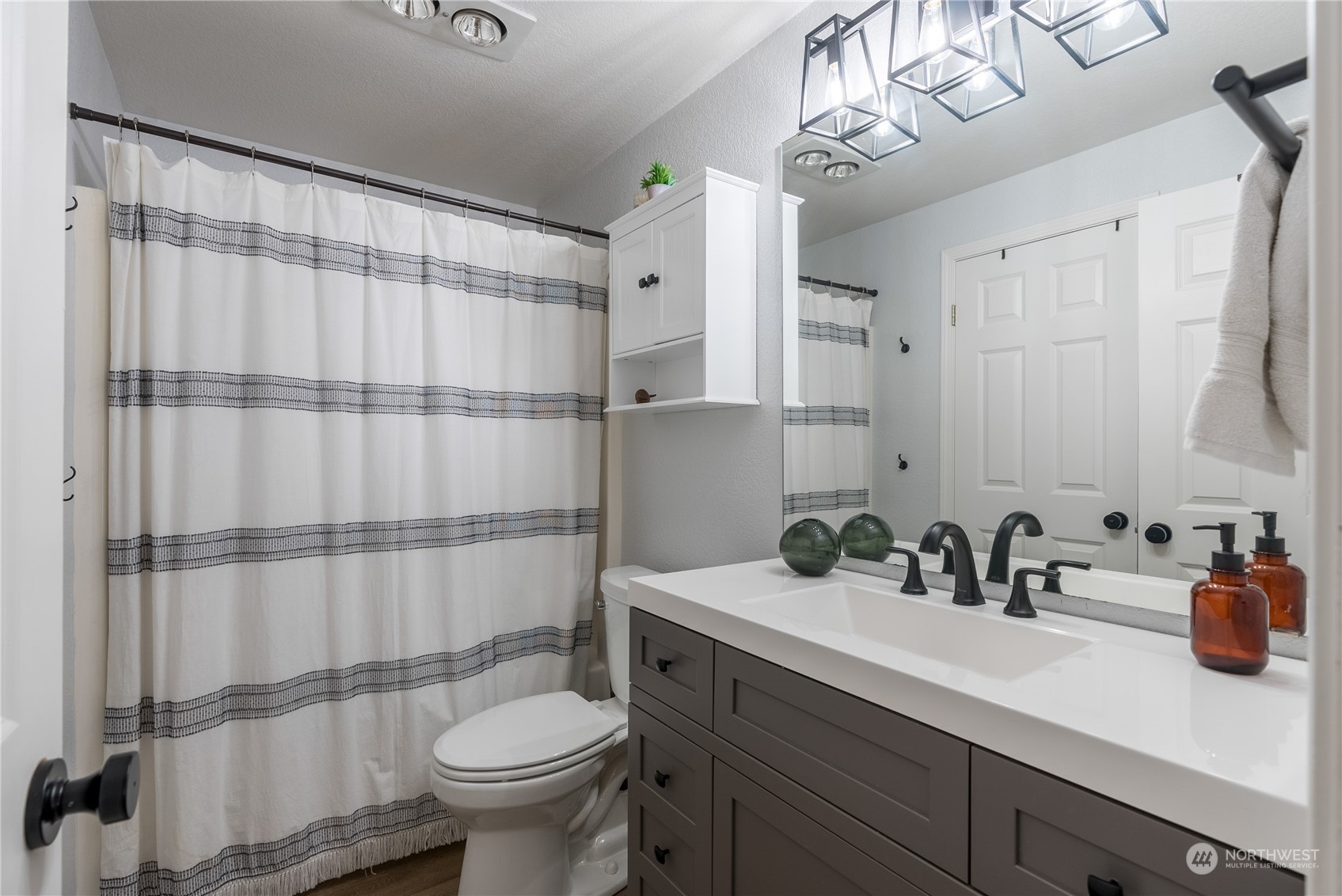 16520 4th Drive Southeast Bothell, WA 98012 - Photo 10 of 32 a bathroom with a sink a toilet and shower curtain
